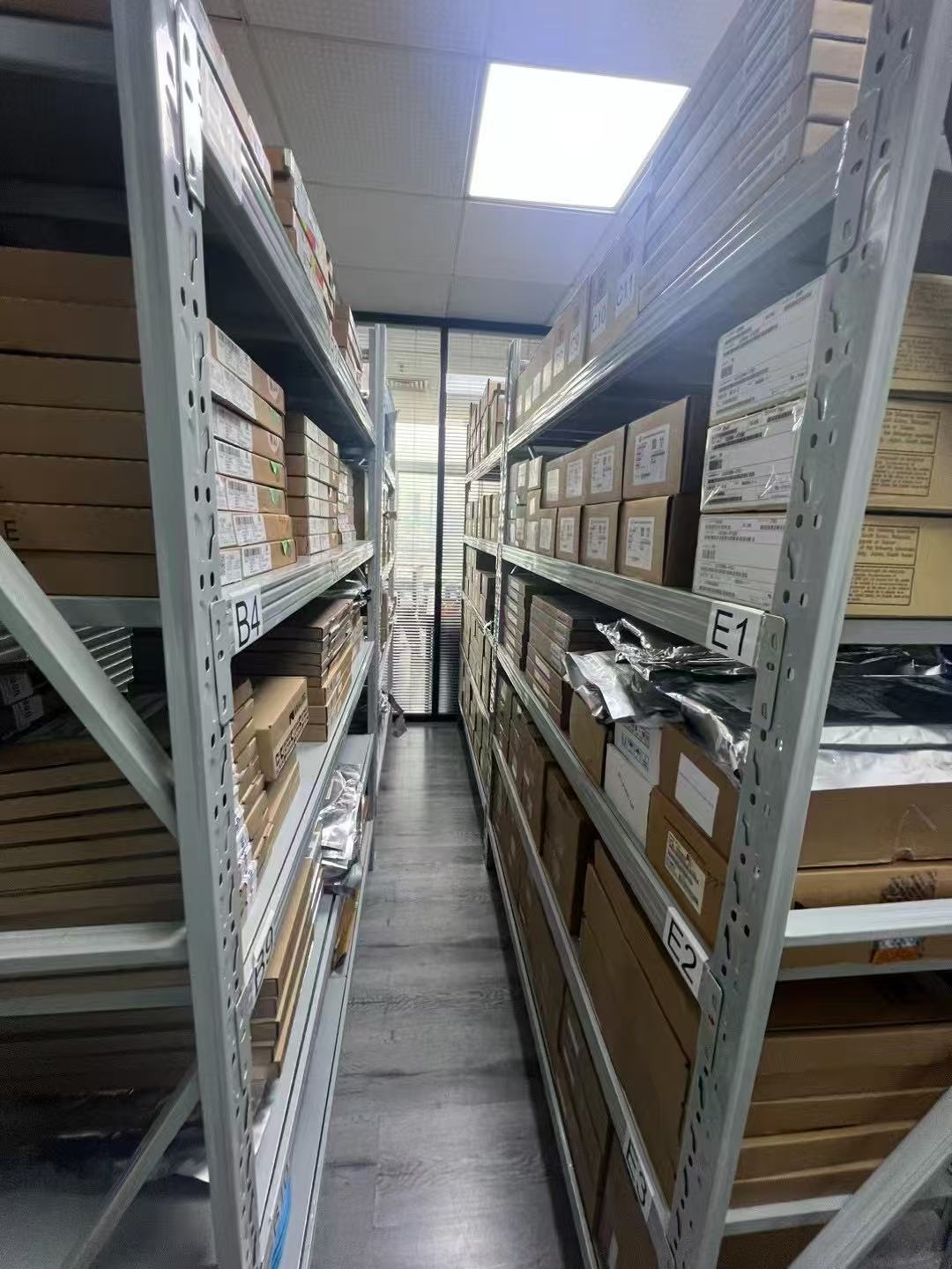 货架通道内按分区摆放的电子元器件库存